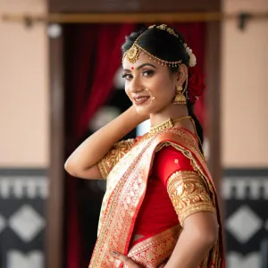Radiant Indian Bride in Traditional Red and Gold Saree