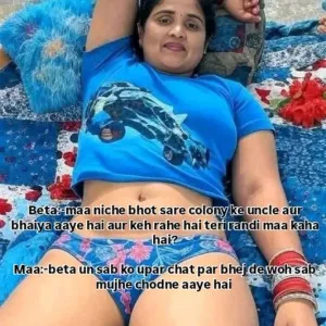 Indian aunty relaxing on floral blanket at beach wearing blue top and shorts