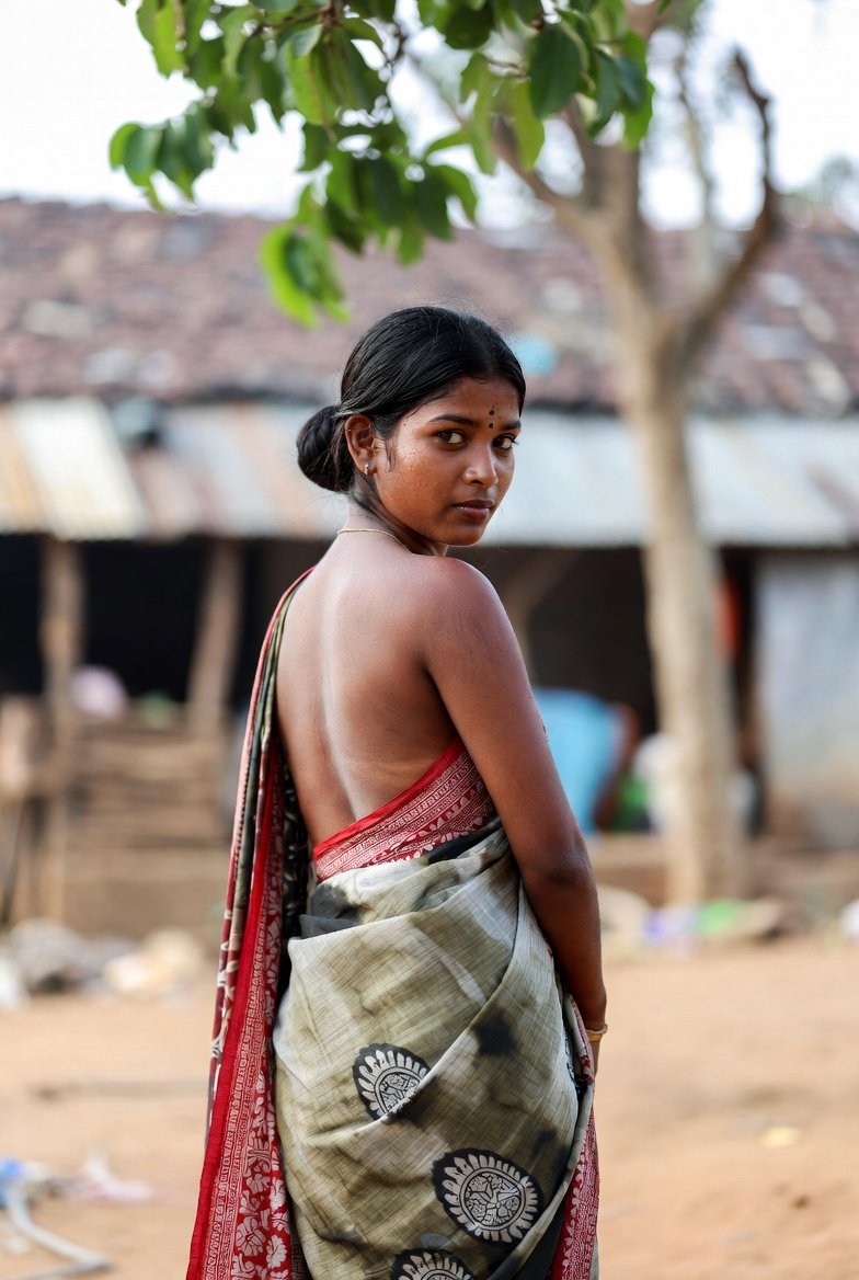 South Indian woman in saree turning back to camera outdoors