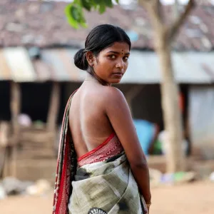 South Indian woman in saree turning back to camera outdoors