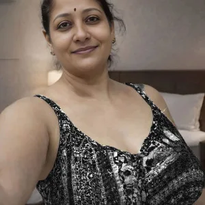 Indian aunty in glamorous black outfit looks sultry