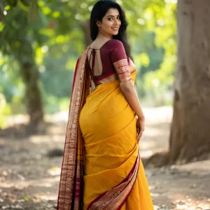Indian woman in yellow saree smiling outdoors