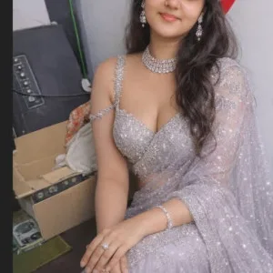 Indian woman in silver lehenga with jewelry smiling