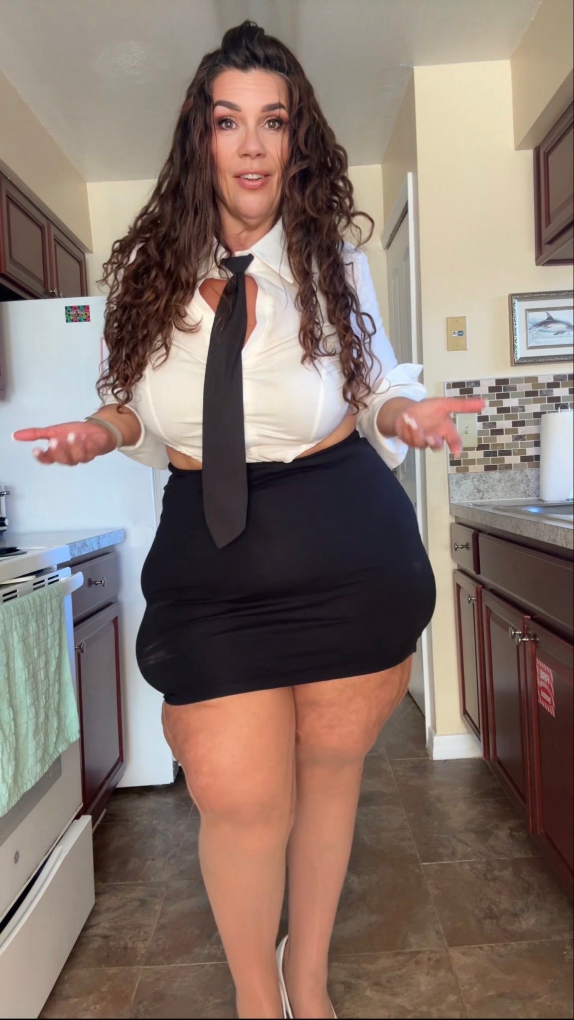 thin aunty confidently strides in her workspace with white shirt and black skirt