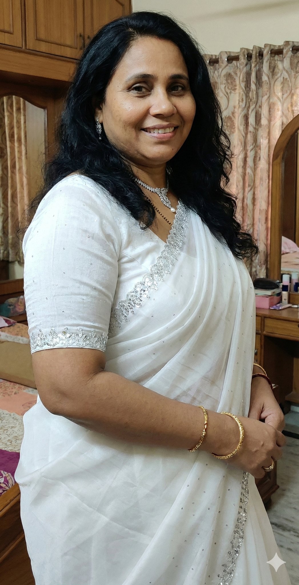Captivating Indian woman in white embroidered saree smiling brightly