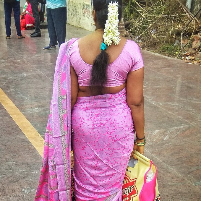 Desi aunt in pink saree standing outdoors