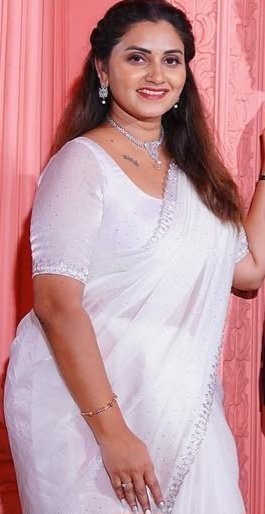 Desi aunty in white saree smiling gracefully