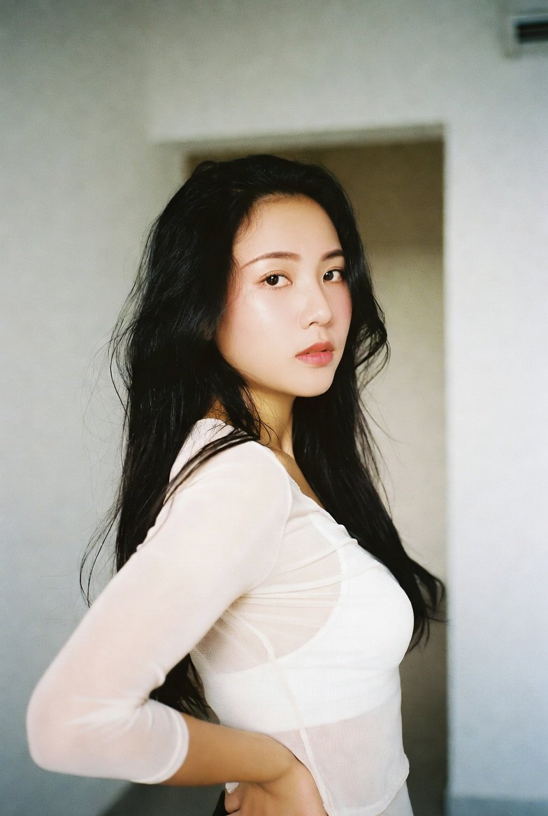 Stunning Indian woman in sheer white top with seductive expression