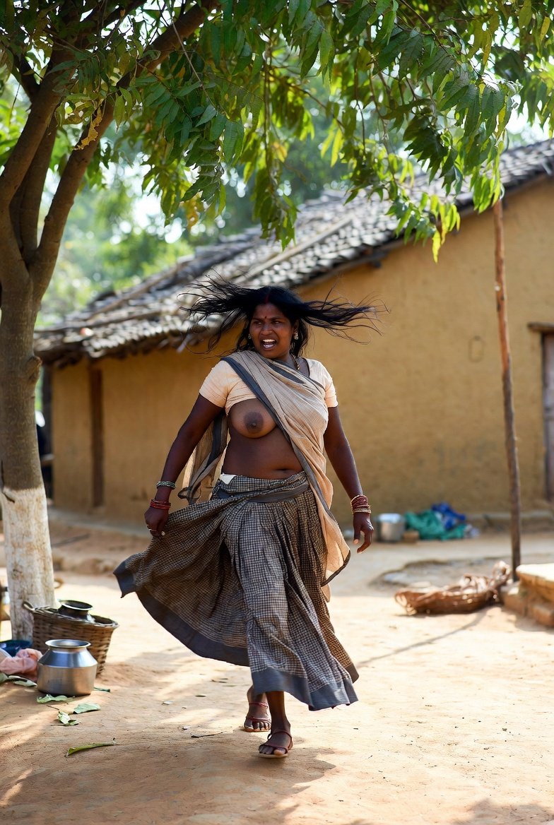 Passionate Indian aunty dancing in village with saree swirling