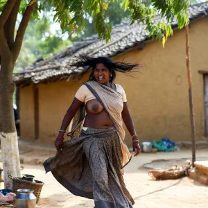 Passionate Indian aunty dancing in village with saree swirling