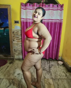 Confident Indian bhabhi in red bikini showing curves indoors