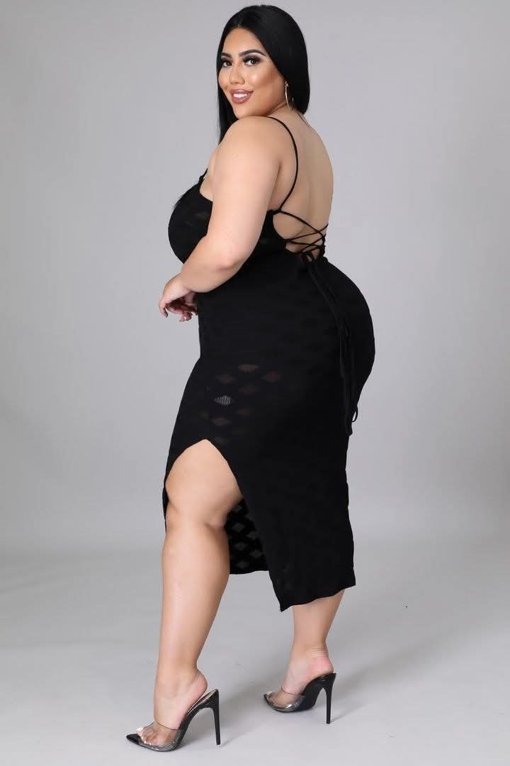 Curvy Indian aunty in black dress posing confidently in studio