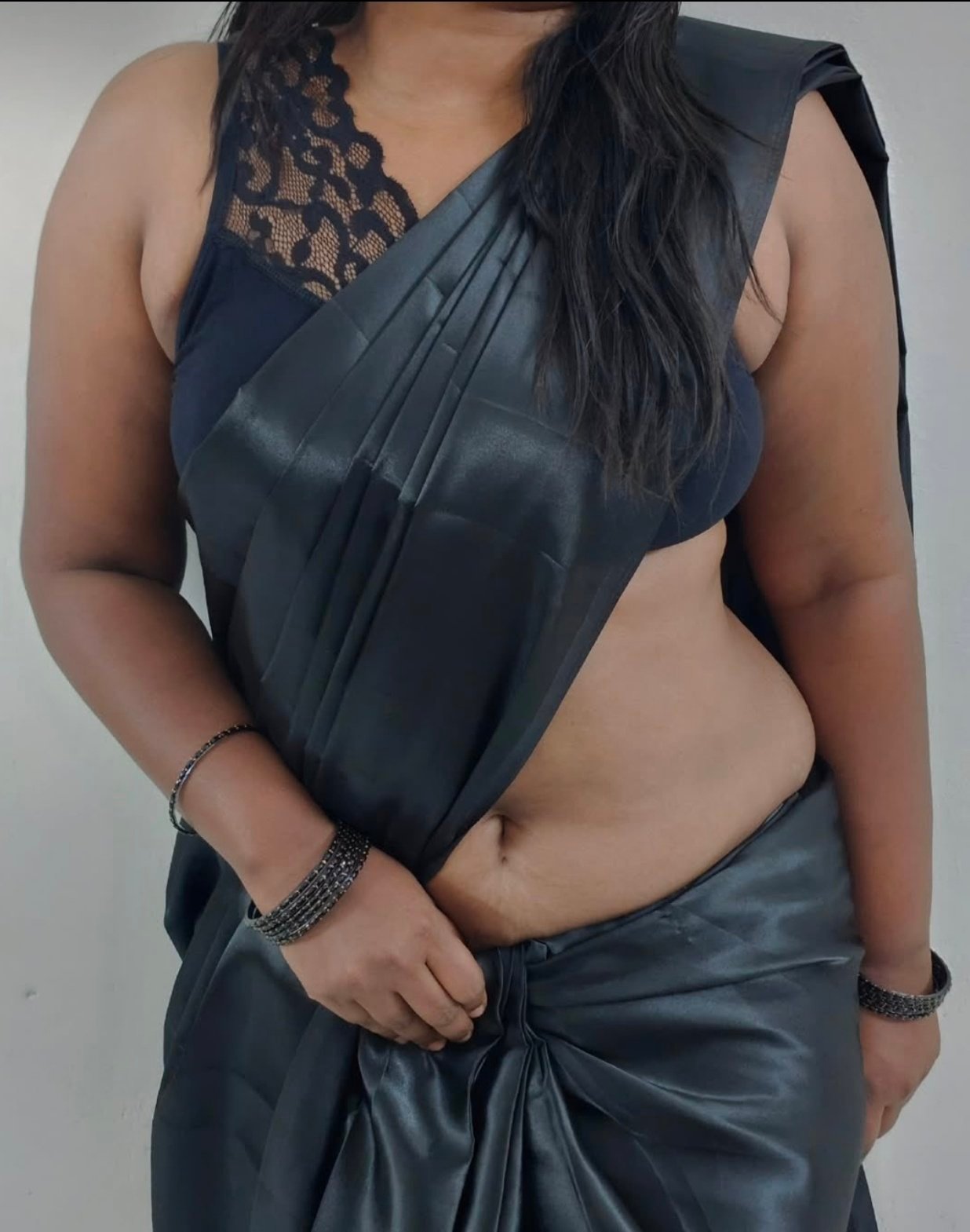Voluptuous bhabhi in black saree posing confidently indoors